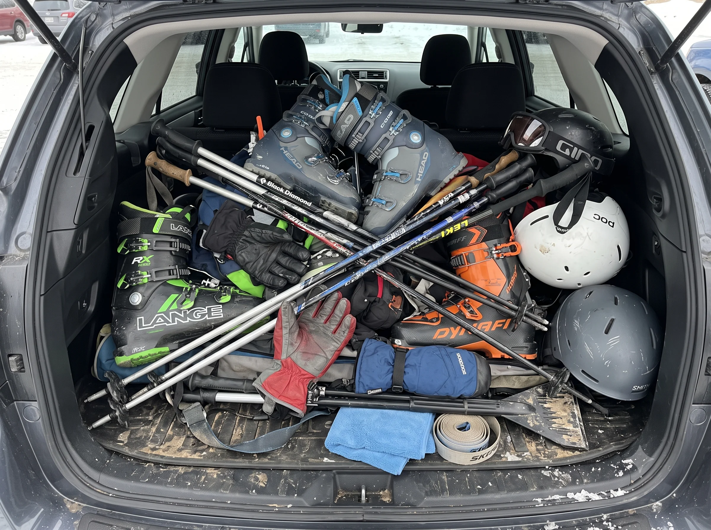 Ski gear crammed into a car trunk