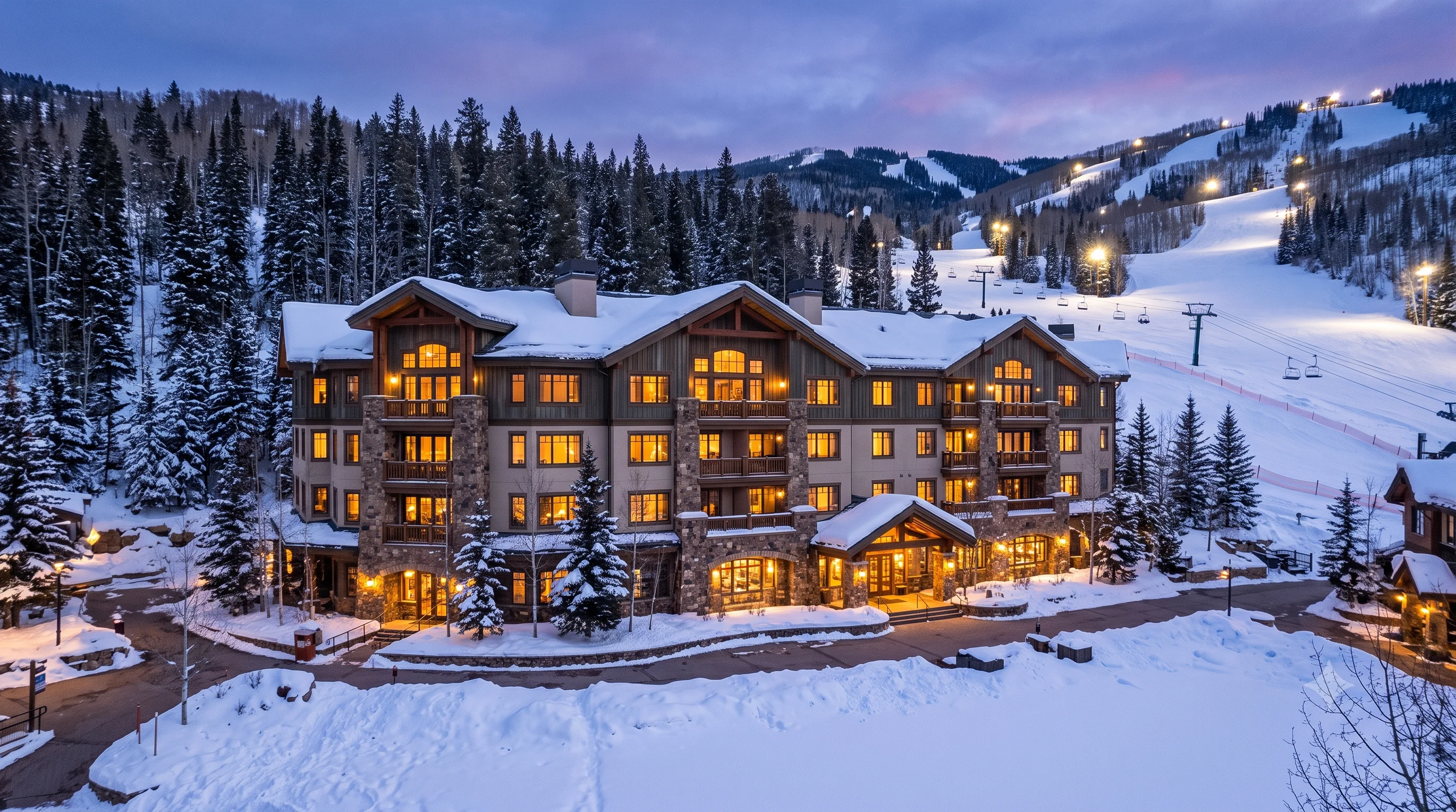 Beaver Creek Lodge exterior at dusk with ski slopes in background
